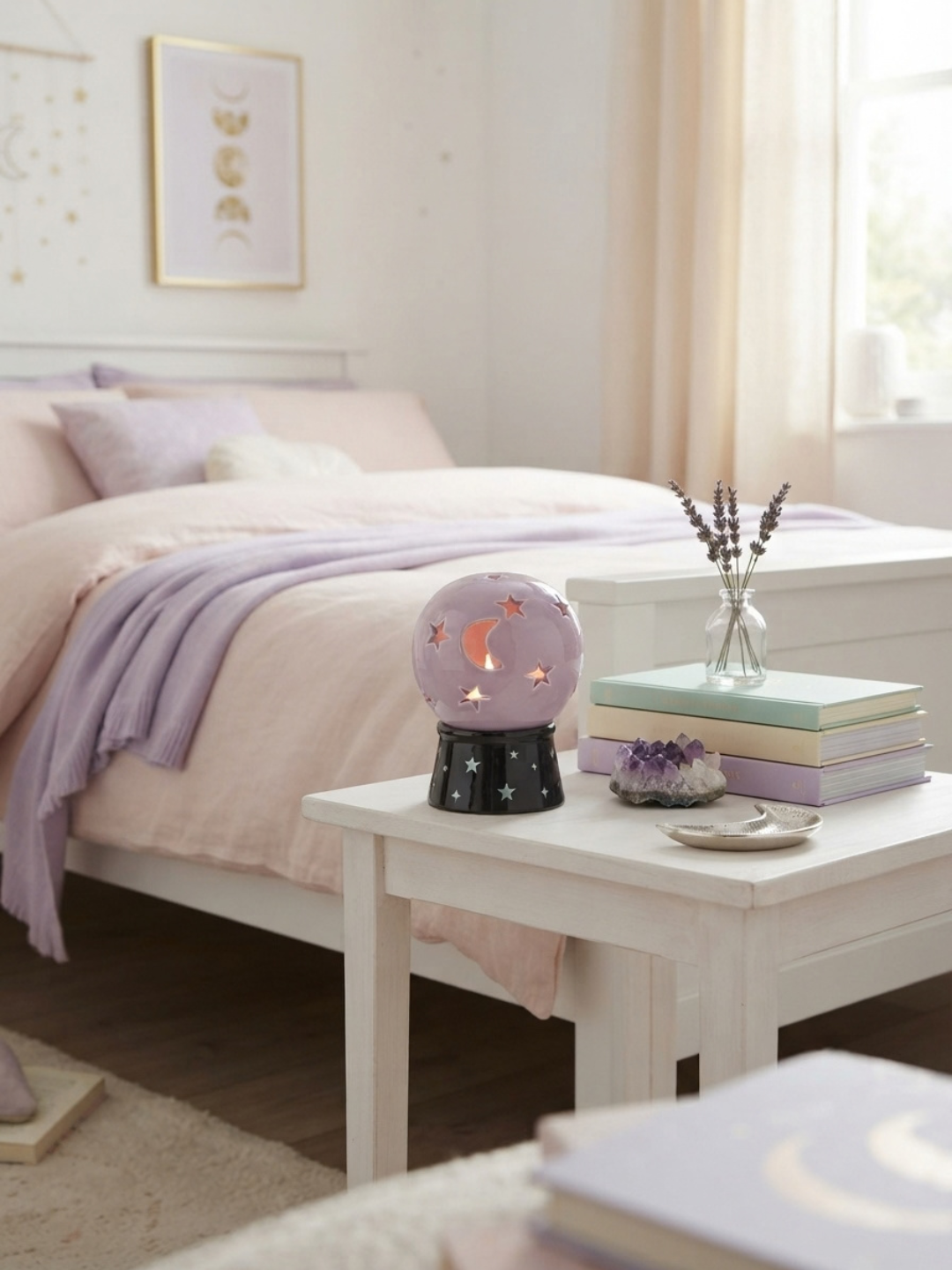 A pastel bedroom scene with a white bed, lavender bedding, and a small bedside table holding a glowing pastel lavender crystal ball tea light holder and incense burner , stacked books, and a glass vase with dried stems.
